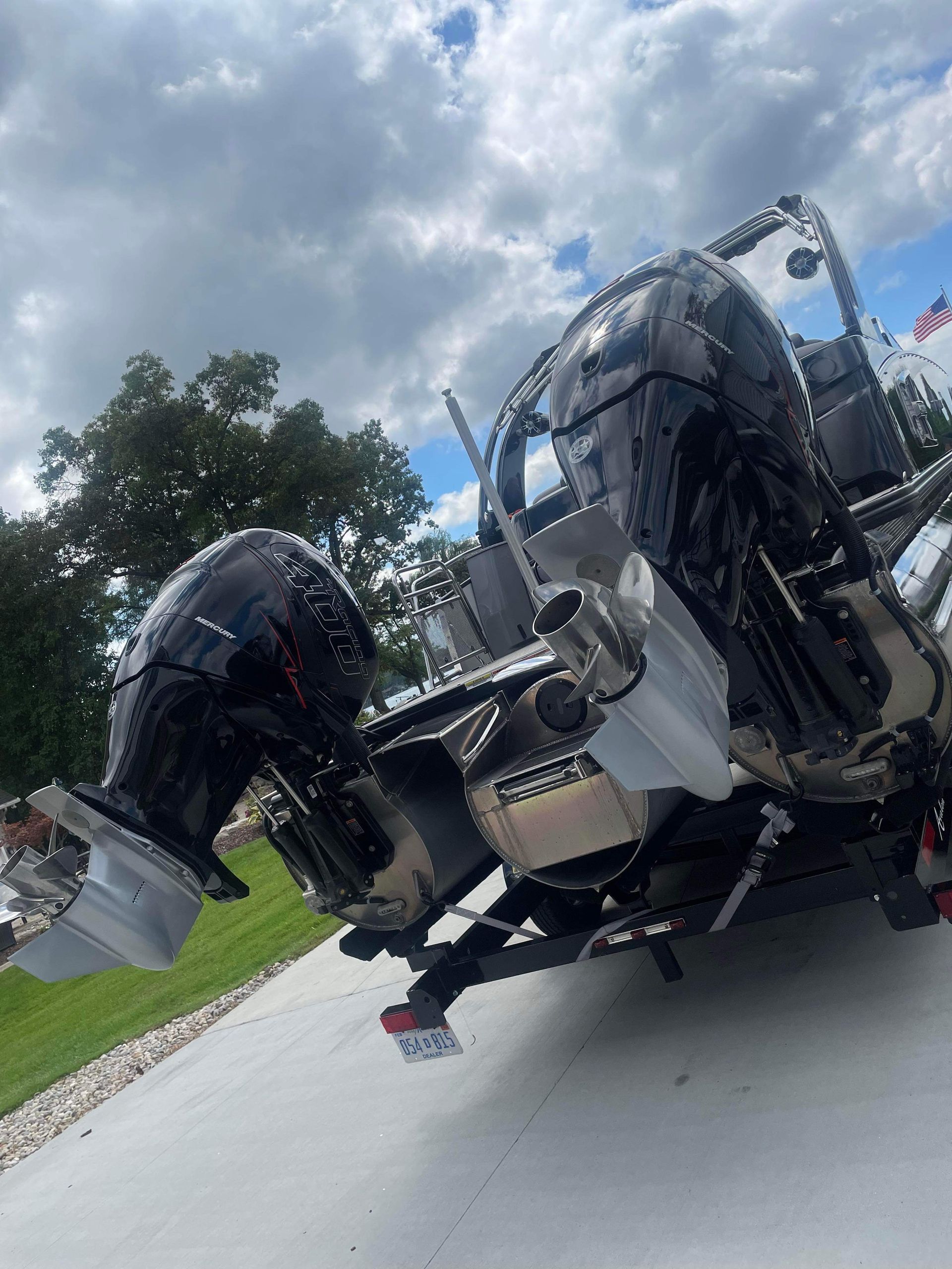 Overturned trailer with machinery parts on a road under cloudy sky