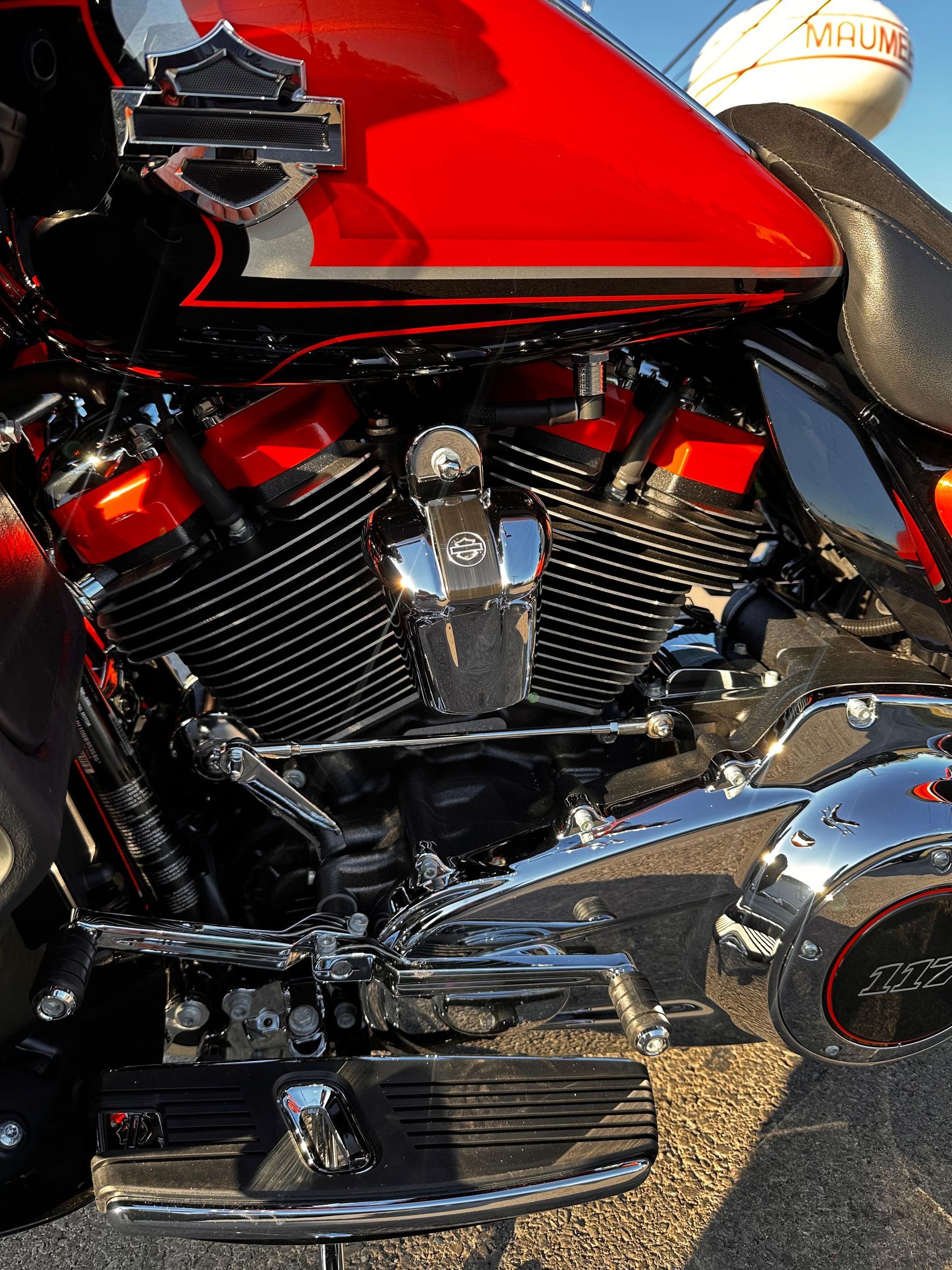 Close-up of a red and chrome motorcycle engine and side panel