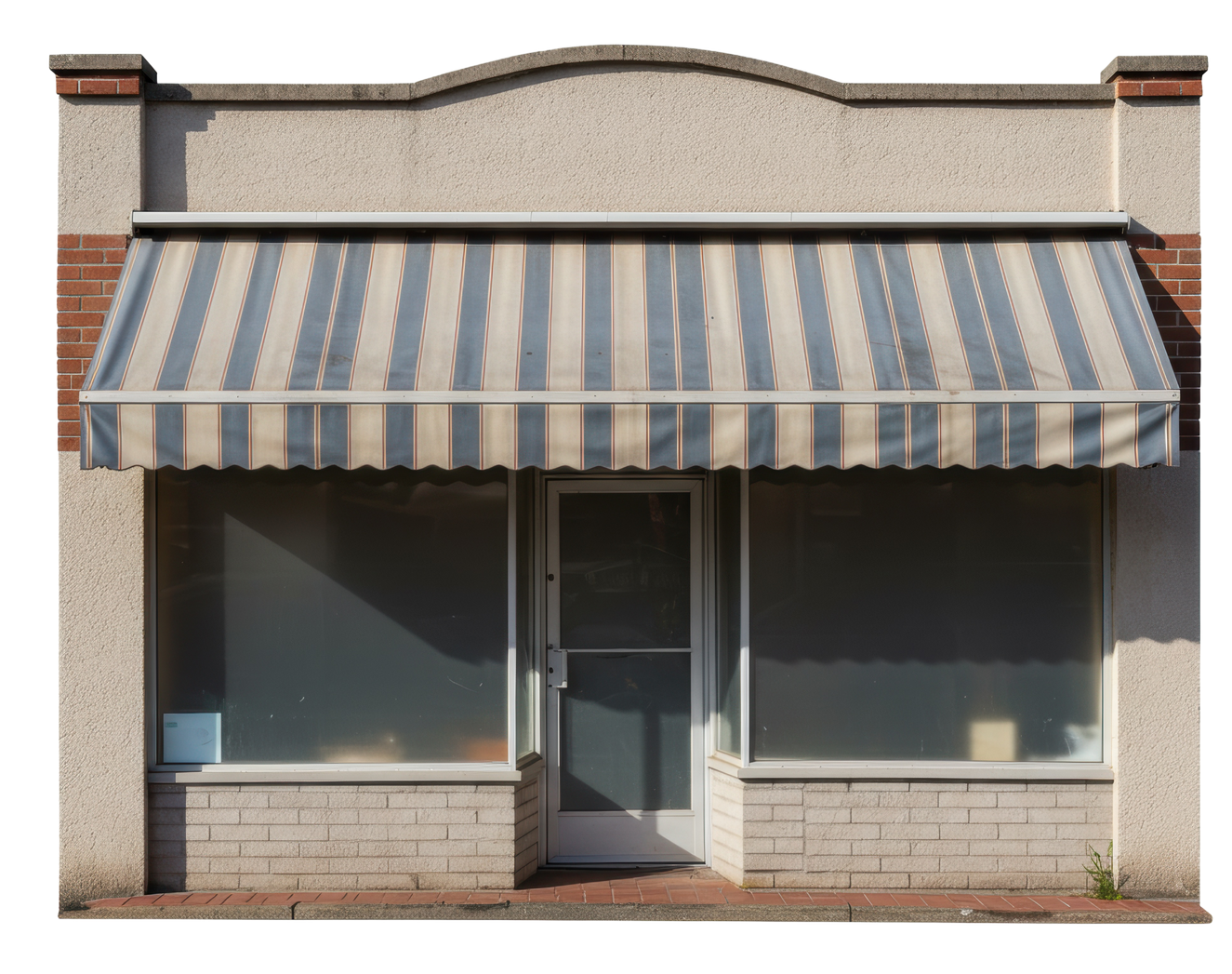 Storefront with striped awning, brick and tan facade, and large windows.
