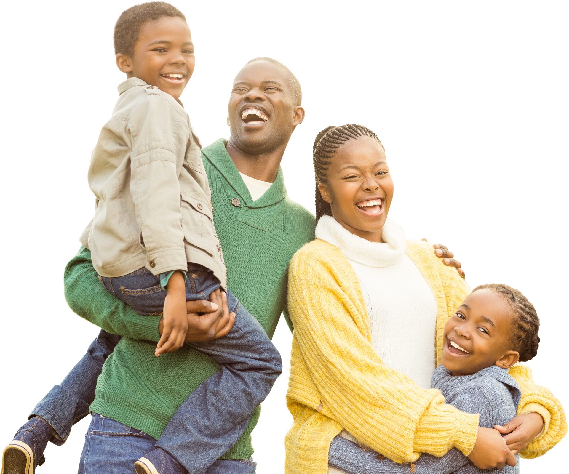 Family of four laughing together, embracing each other outdoors.