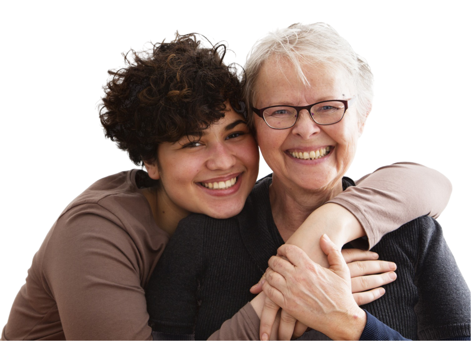 Young person with curly hair hugging a person wearing glasses, both smiling.