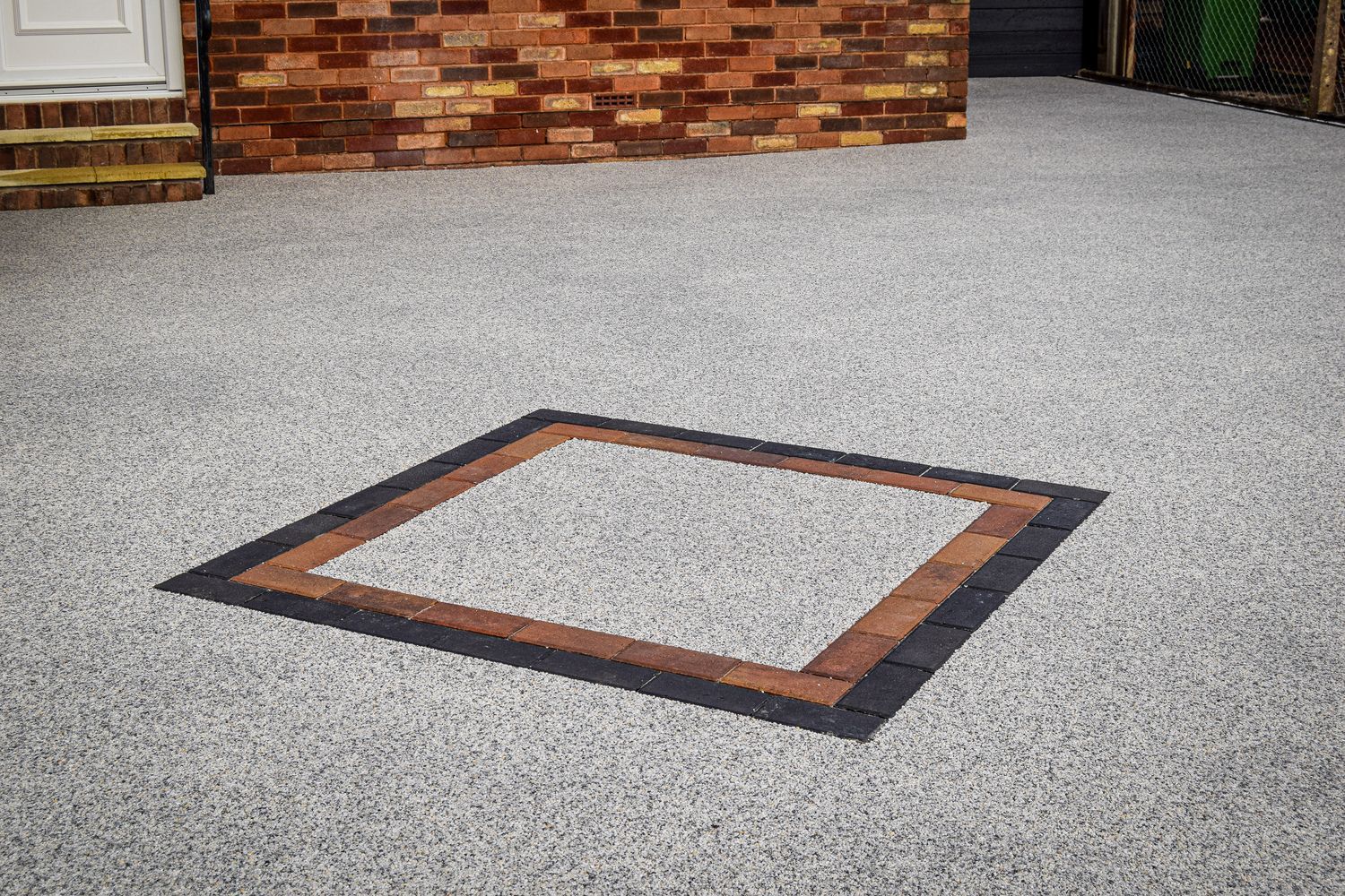 Red and black diamond on a driveway.