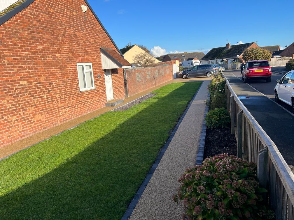 Golden resin pathway with grass either side.