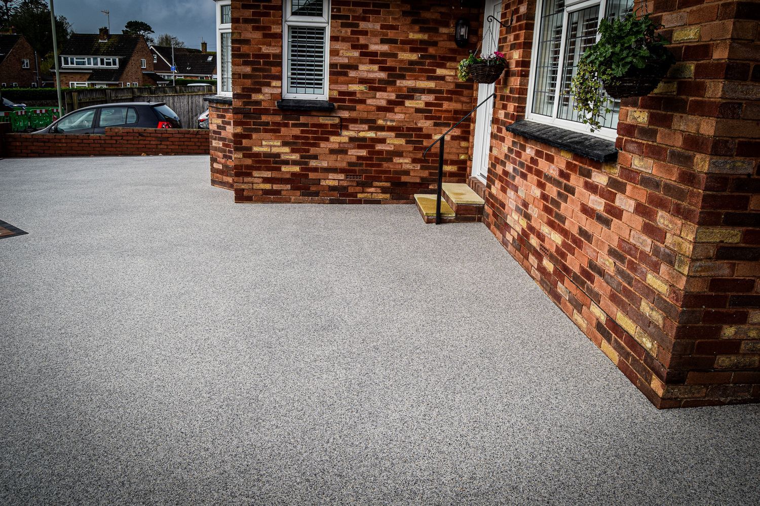 Grey resin driveway in front of a. private property.