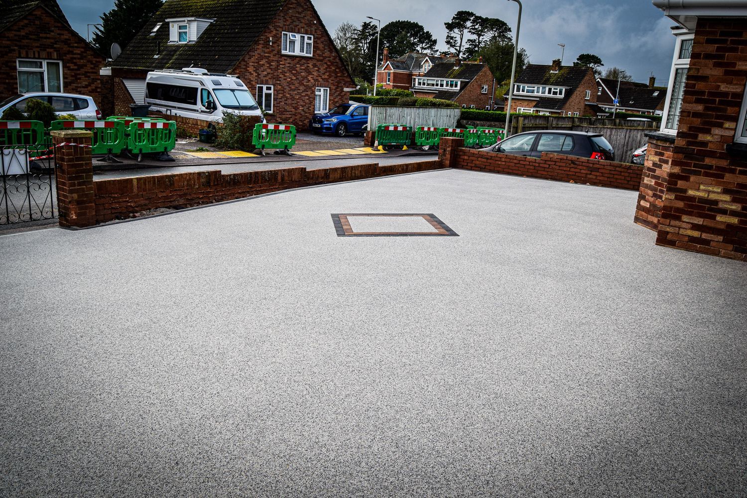 Light grey resin driveway.
