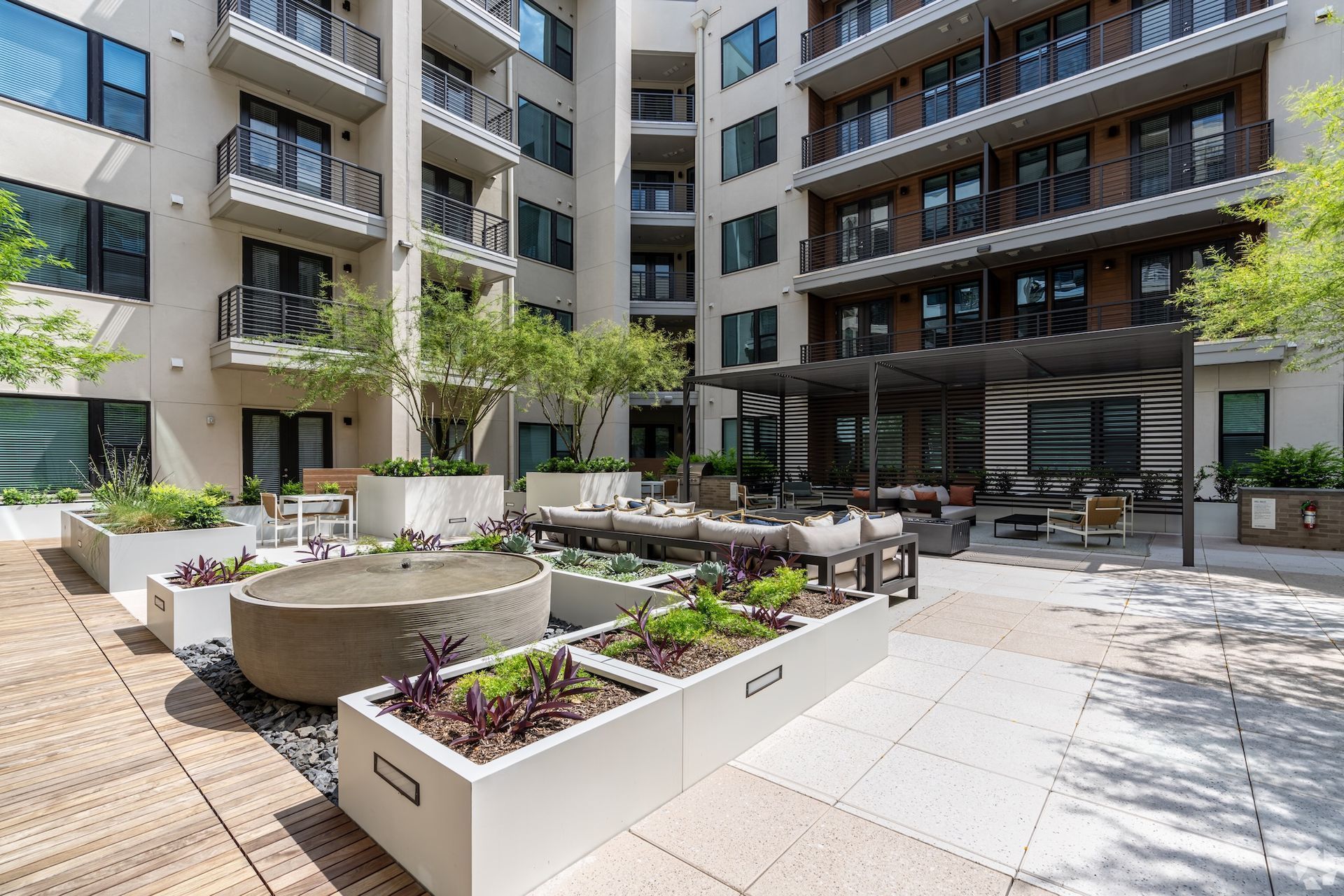 Landscaped courtyard with grills, communal tables and a circular fire pit.