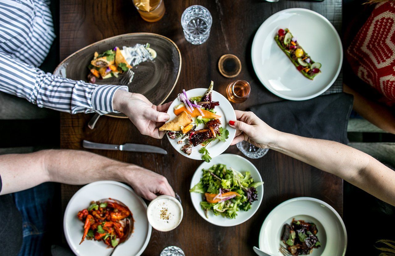 A group of people are sitting at a table eating food.