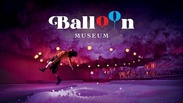 A man is flying through the air at the balloon museum.