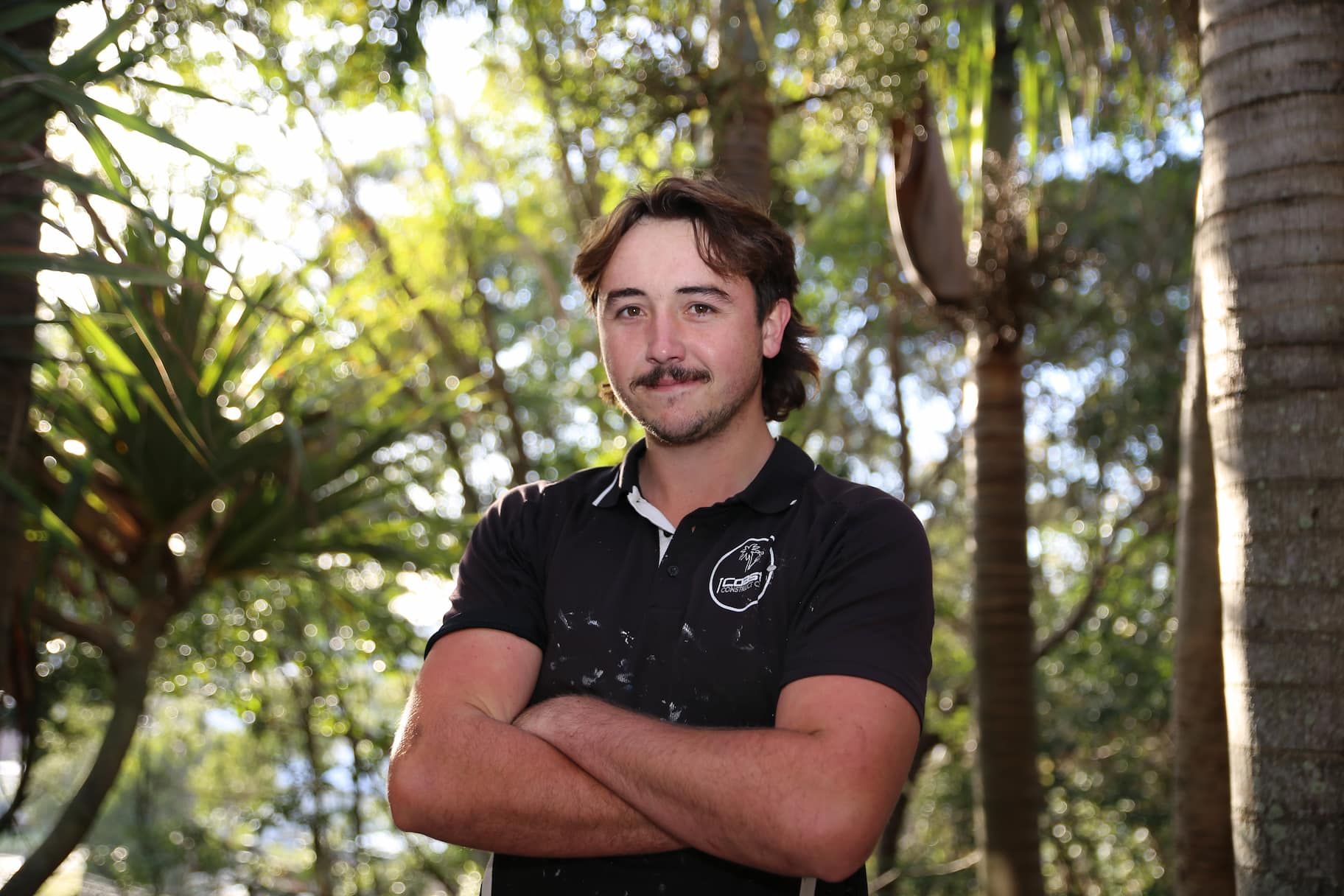 Man with crossed armed gets photo taken - Builder Gold Coast