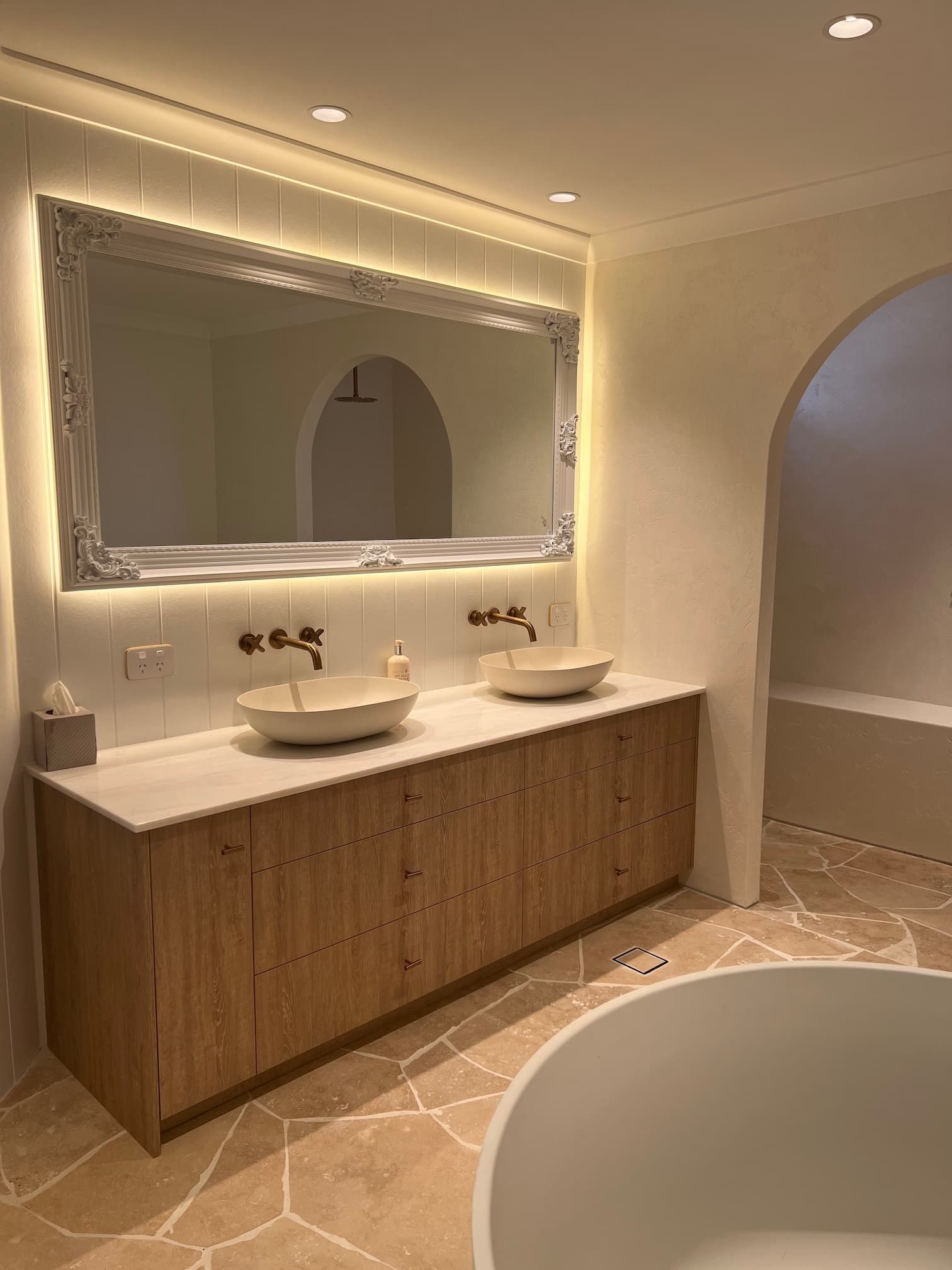 a recently renovated bathroom with two sinks and a mirror
