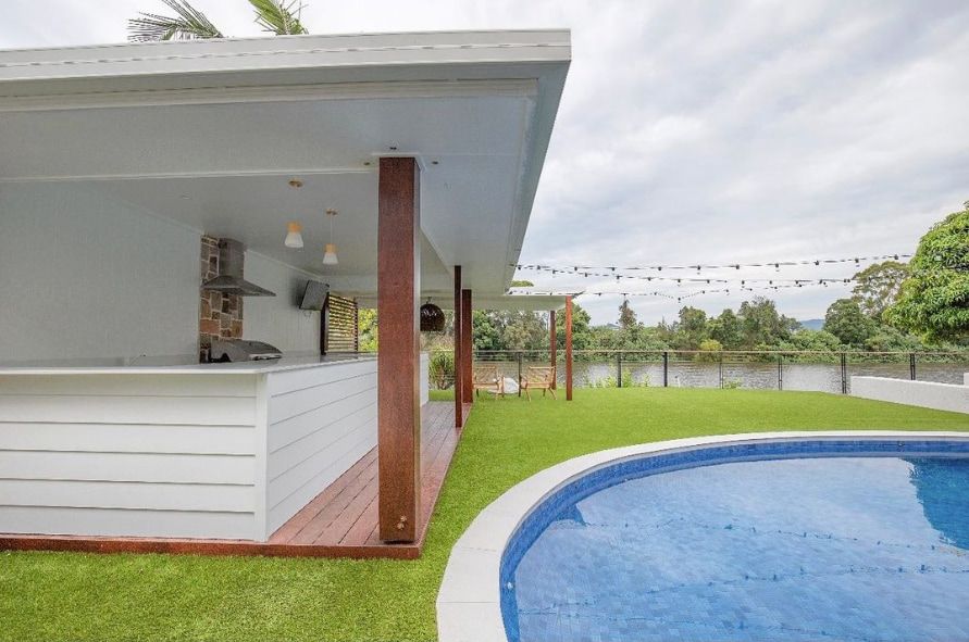 Luxury outdoor entertainment area with a pool and outdoor kitchen