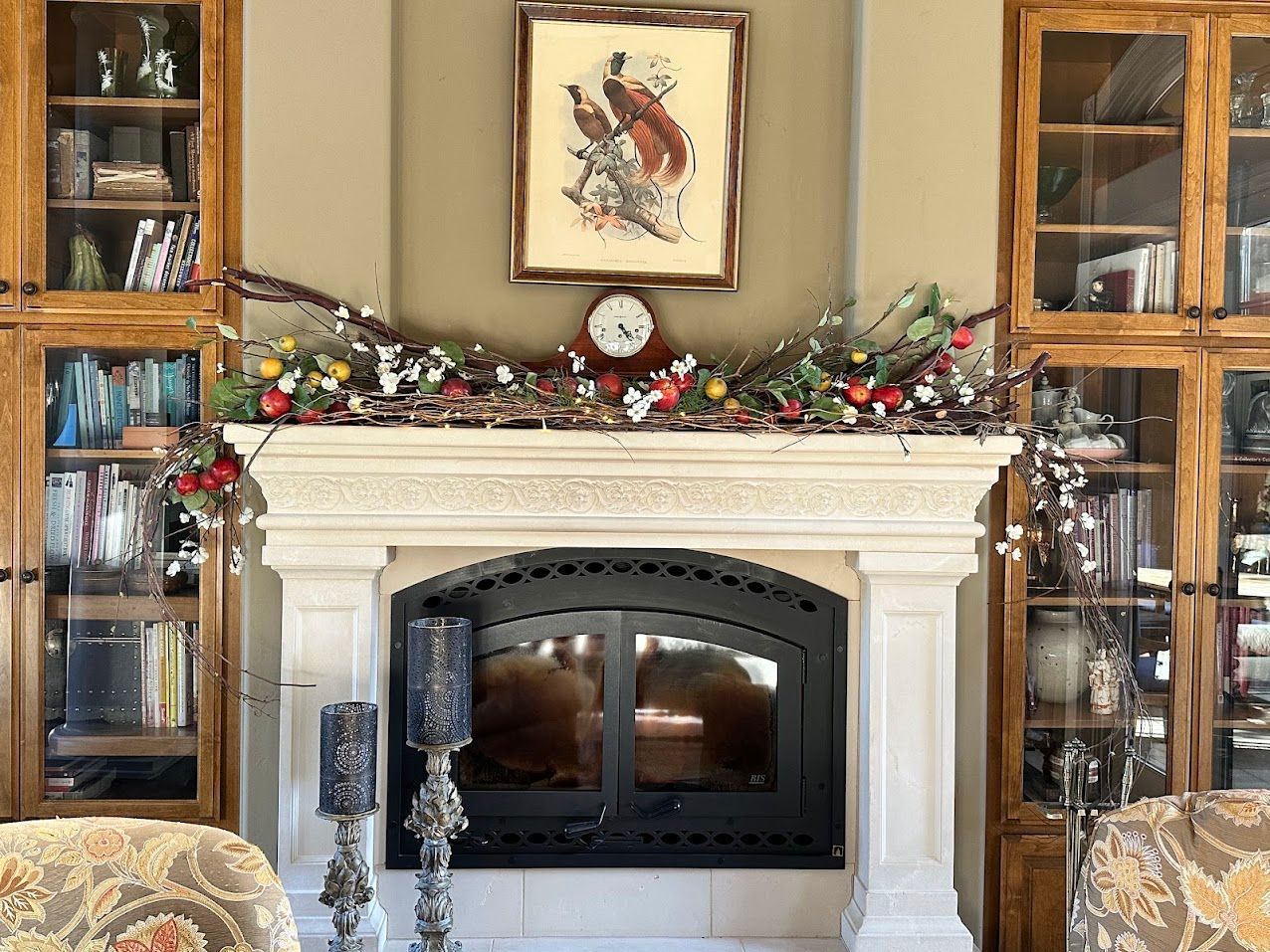 Fall mantel decorated with apple branches, red and green apples, and natural branches