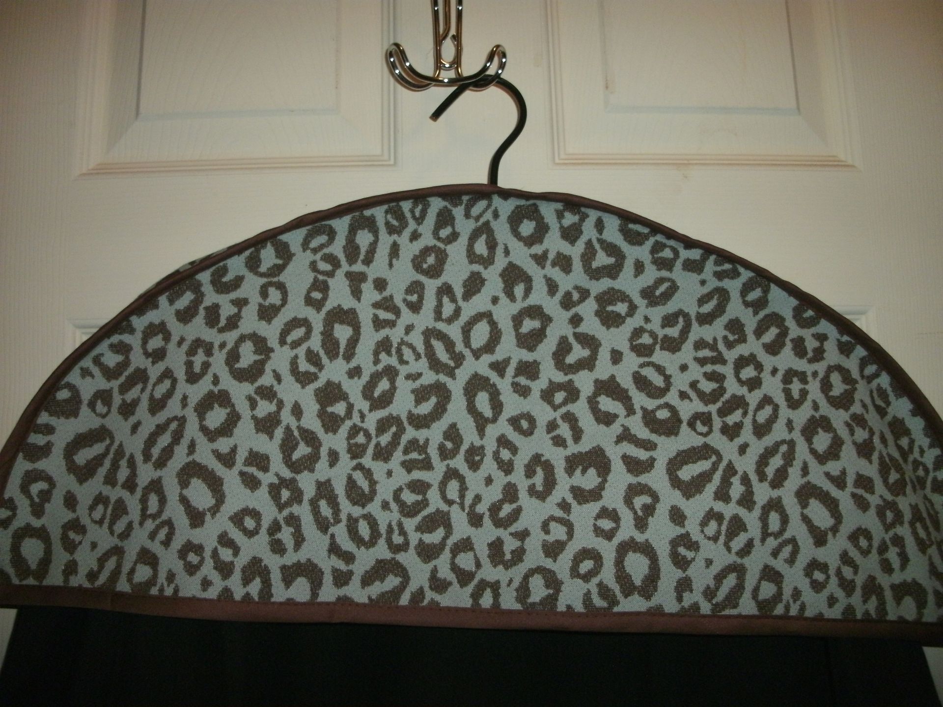 Leopard-print garment cover hanging on a door