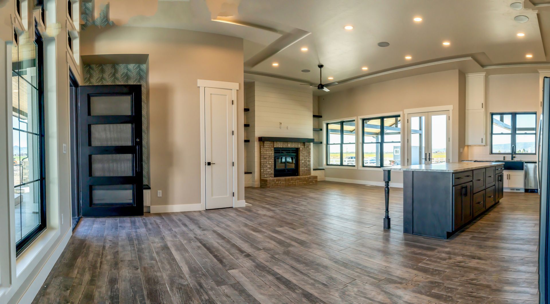 Interior view of a newly built home looking from the kitchen into the living room.