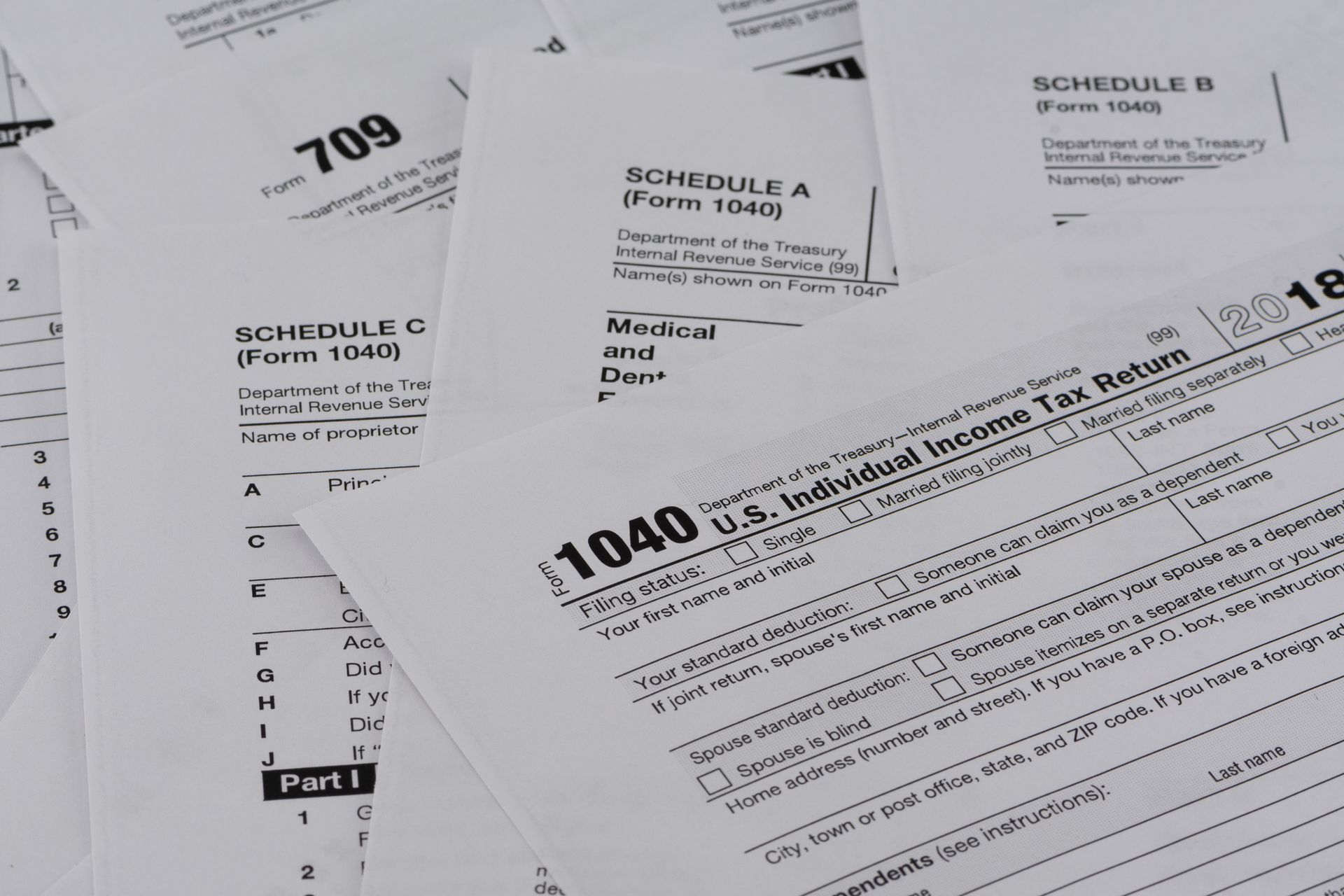 1040 tax forms are stacked on top of each other