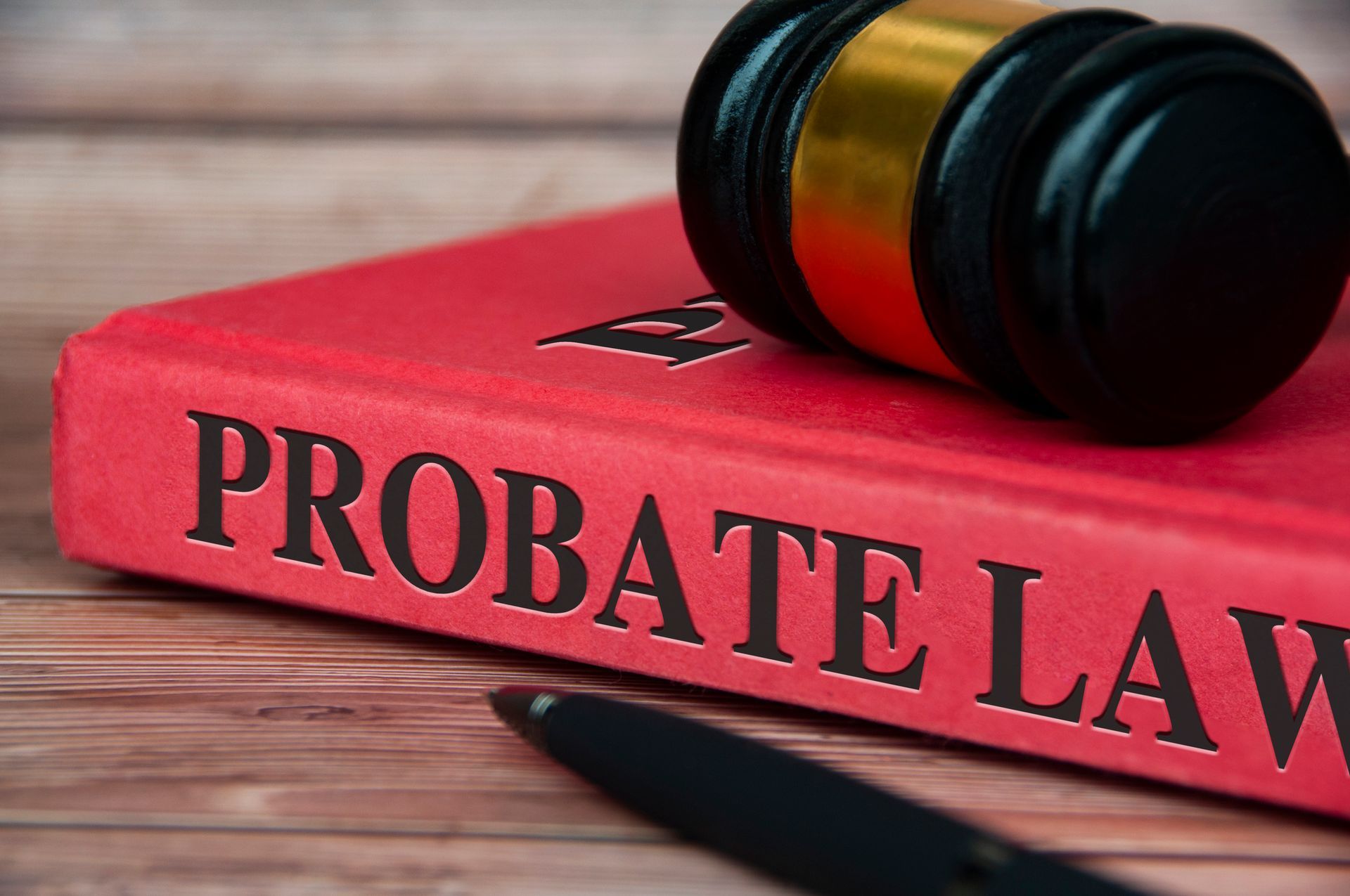 A red book titled probate law with a judge 's gavel on top of it.