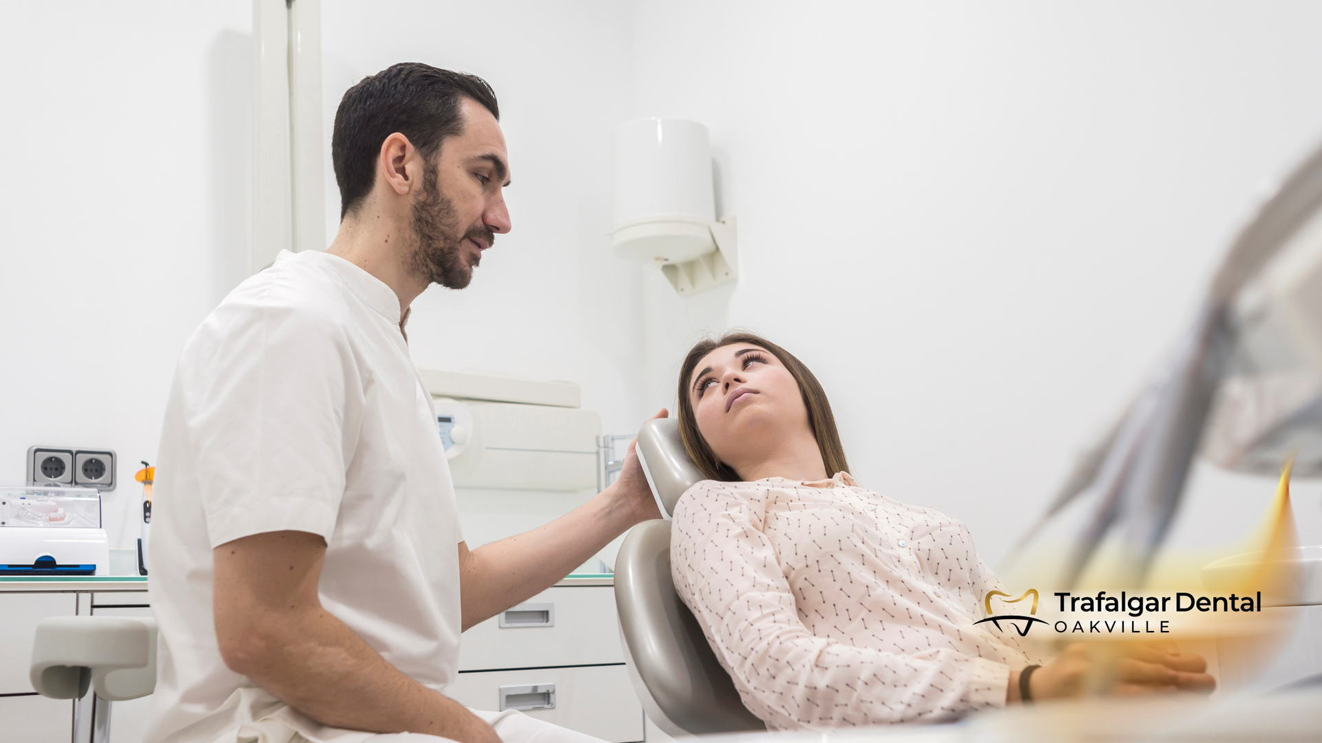 A dentist is examining a woman 's teeth in a dental office.