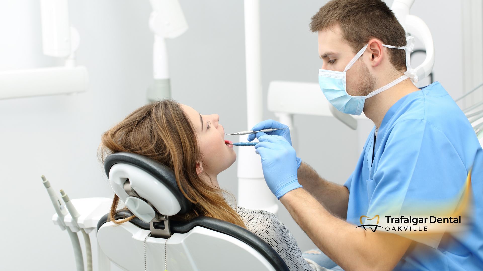 A woman is sitting in a dental chair getting her teeth examined by a dentist.