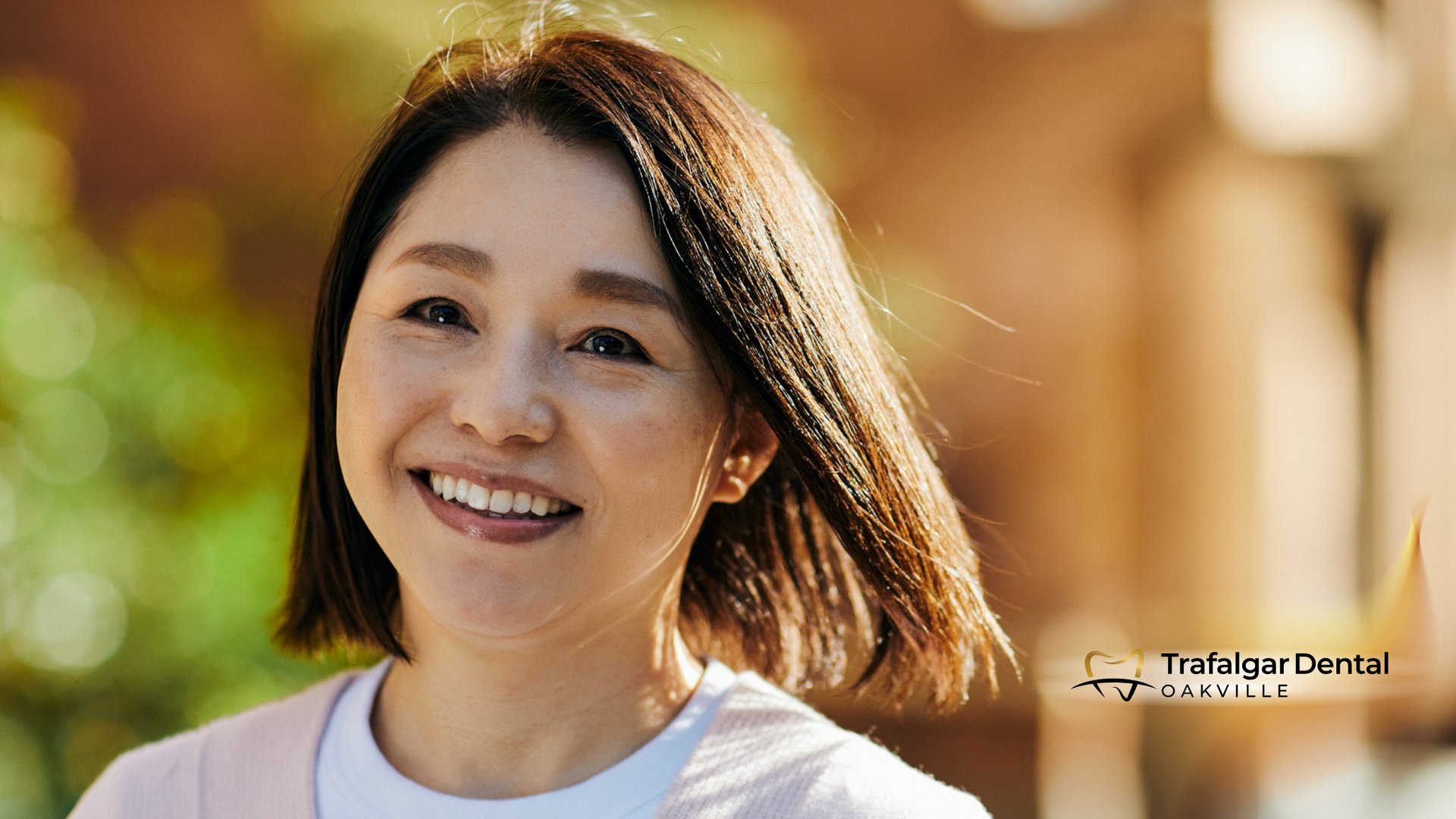 A woman with short hair is smiling and looking at the camera.
