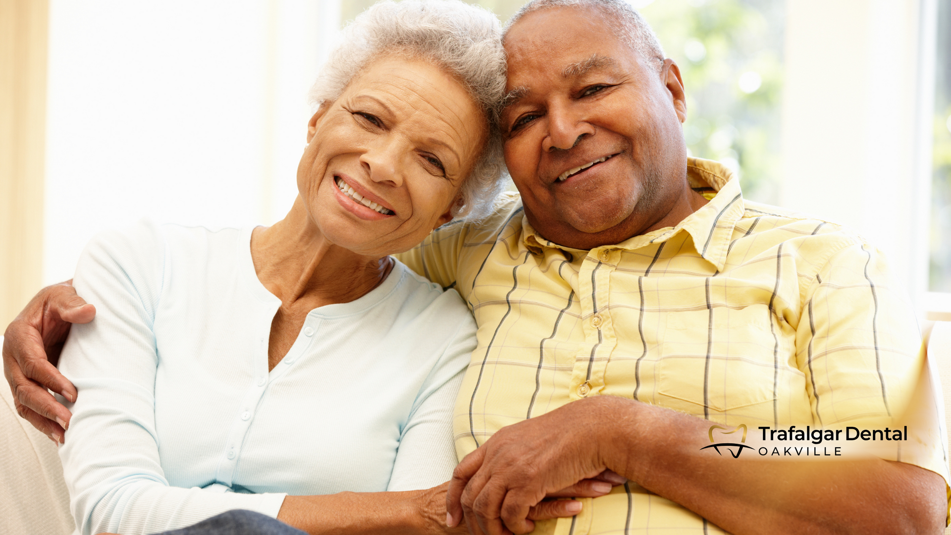 A man and a woman are sitting next to each other on a couch.
