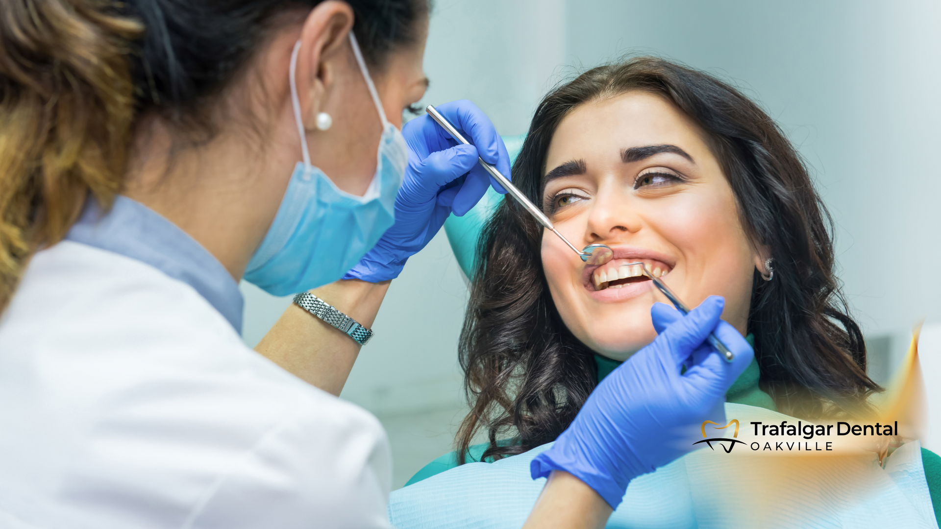 A woman is getting her teeth examined by a dentist.