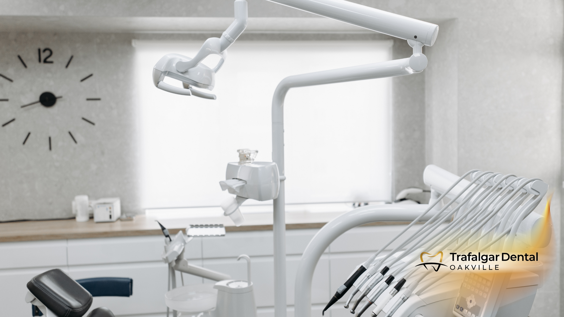 Dental office interior, featuring chair, light, instruments, clock on wall, bright and clean aesthetic.