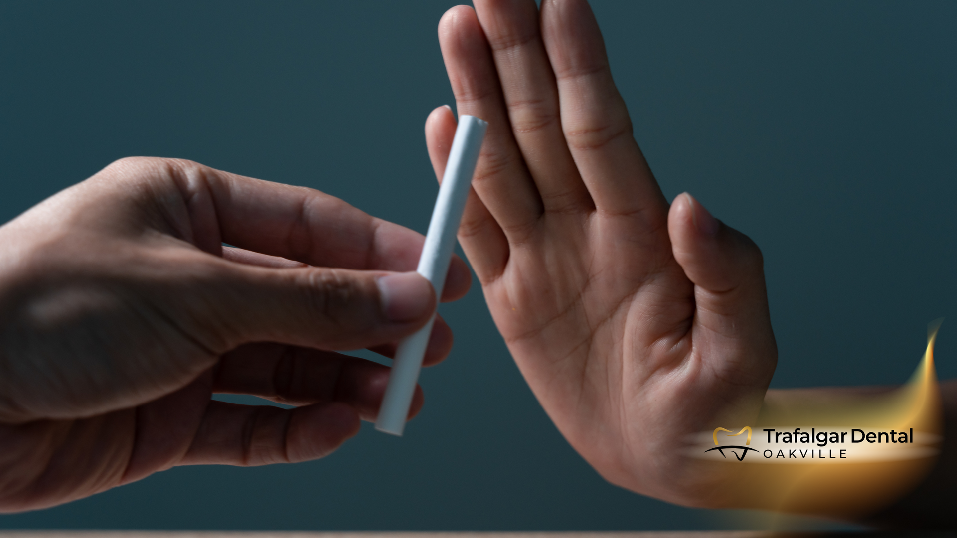 2 hands. 1 holding a cigarette and the other stopping them