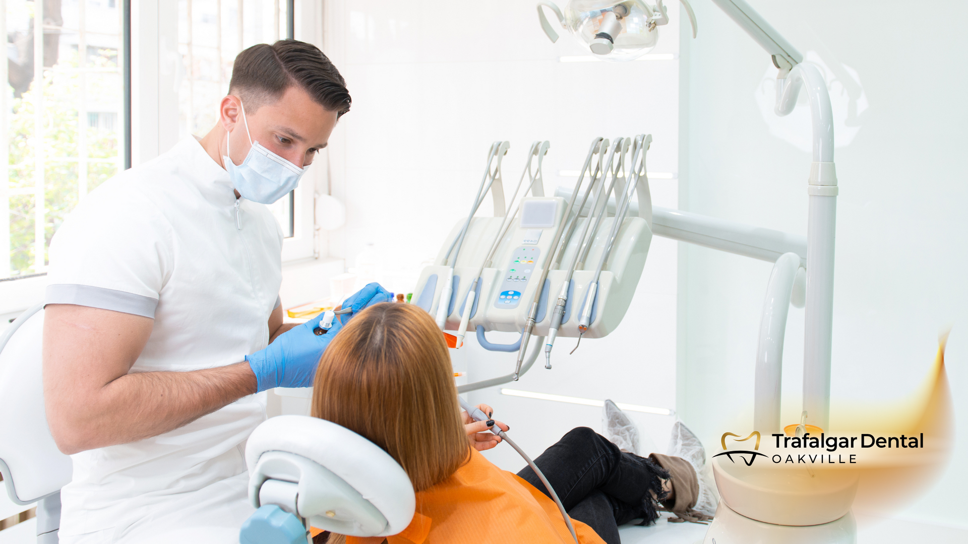 Dentist in a mask and gloves treating a patient's teeth in a dental clinic.