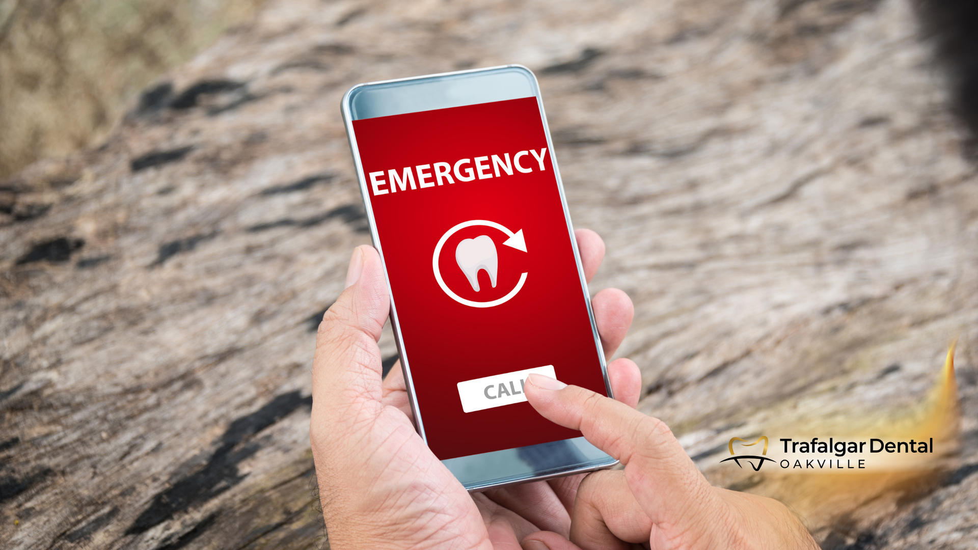 A person is holding a cell phone that says emergency on the screen.