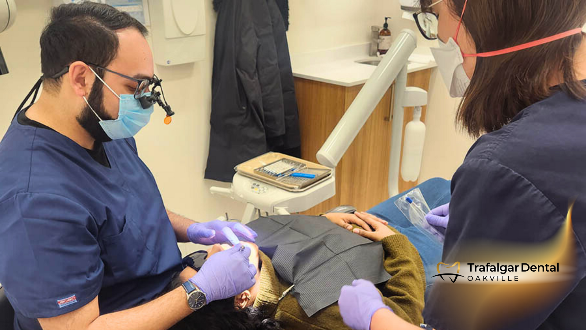 A dentist is examining a patient 's teeth in a dental office.