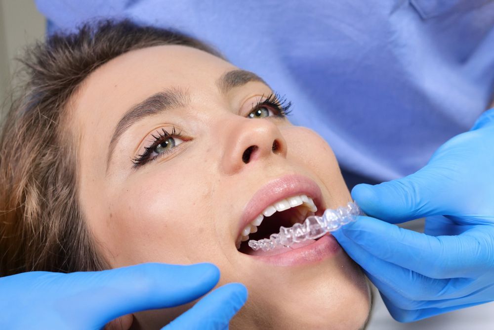 A woman is having her teeth examined by a dentist.