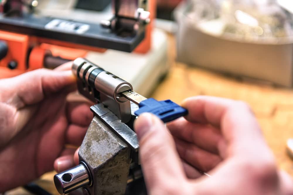 a Person is Cutting a Key With a Machine — Armstrong Locksmiths Ballarat in Ballarat East, VIC