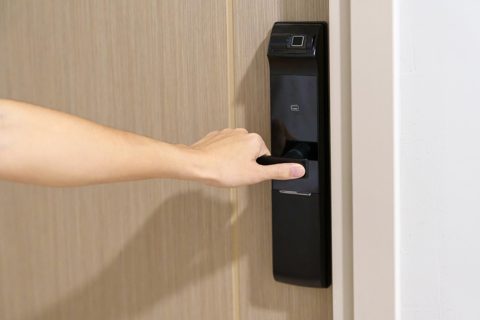 a Person is Opening a Door With a Fingerprint Lock — Armstrong Locksmiths Ballarat in Ballarat East, VIC