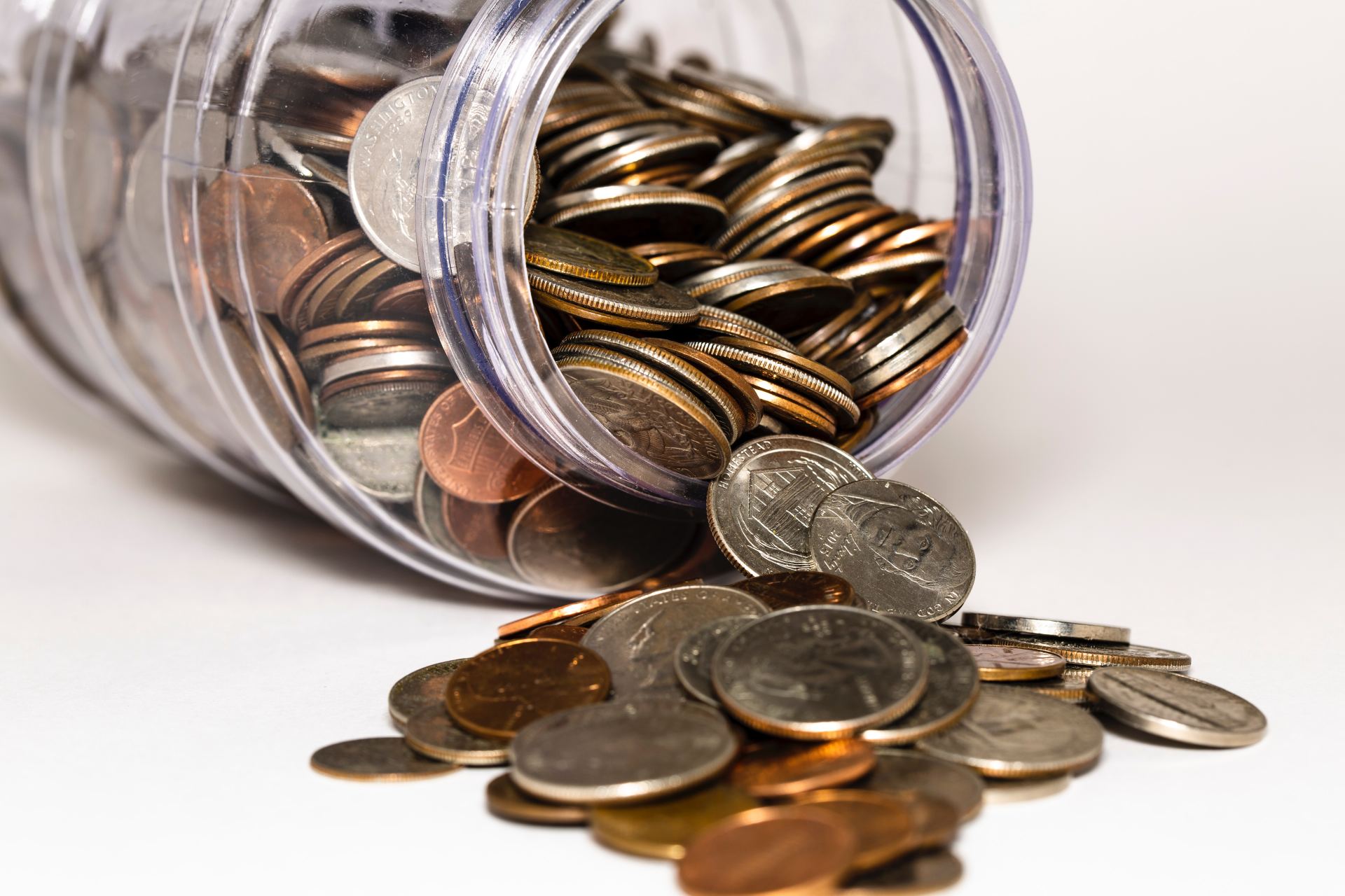 A jar of coins is pouring out of it