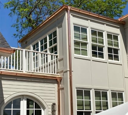 Copper gutters and downspouts on luxury home