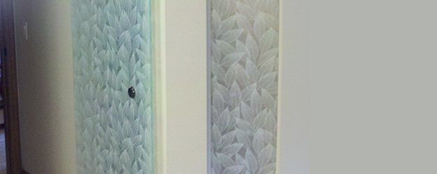 A white wall with a knitted pattern on it.