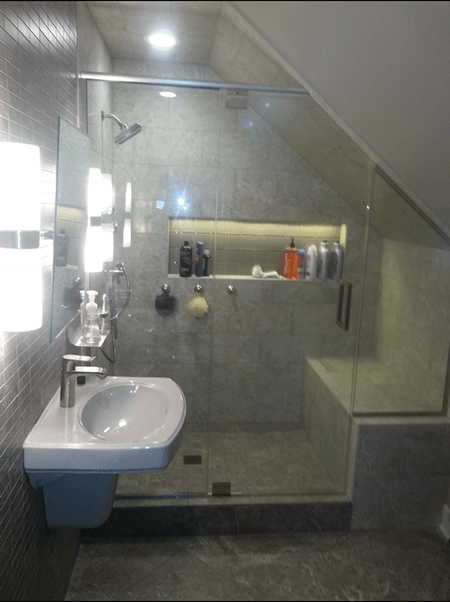A bathroom with a sink and a walk in shower