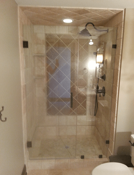 A bathroom with a walk in shower and a toilet