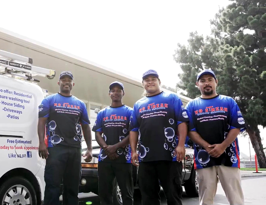 A Group Of Men Are Standing In Front Of A White Van