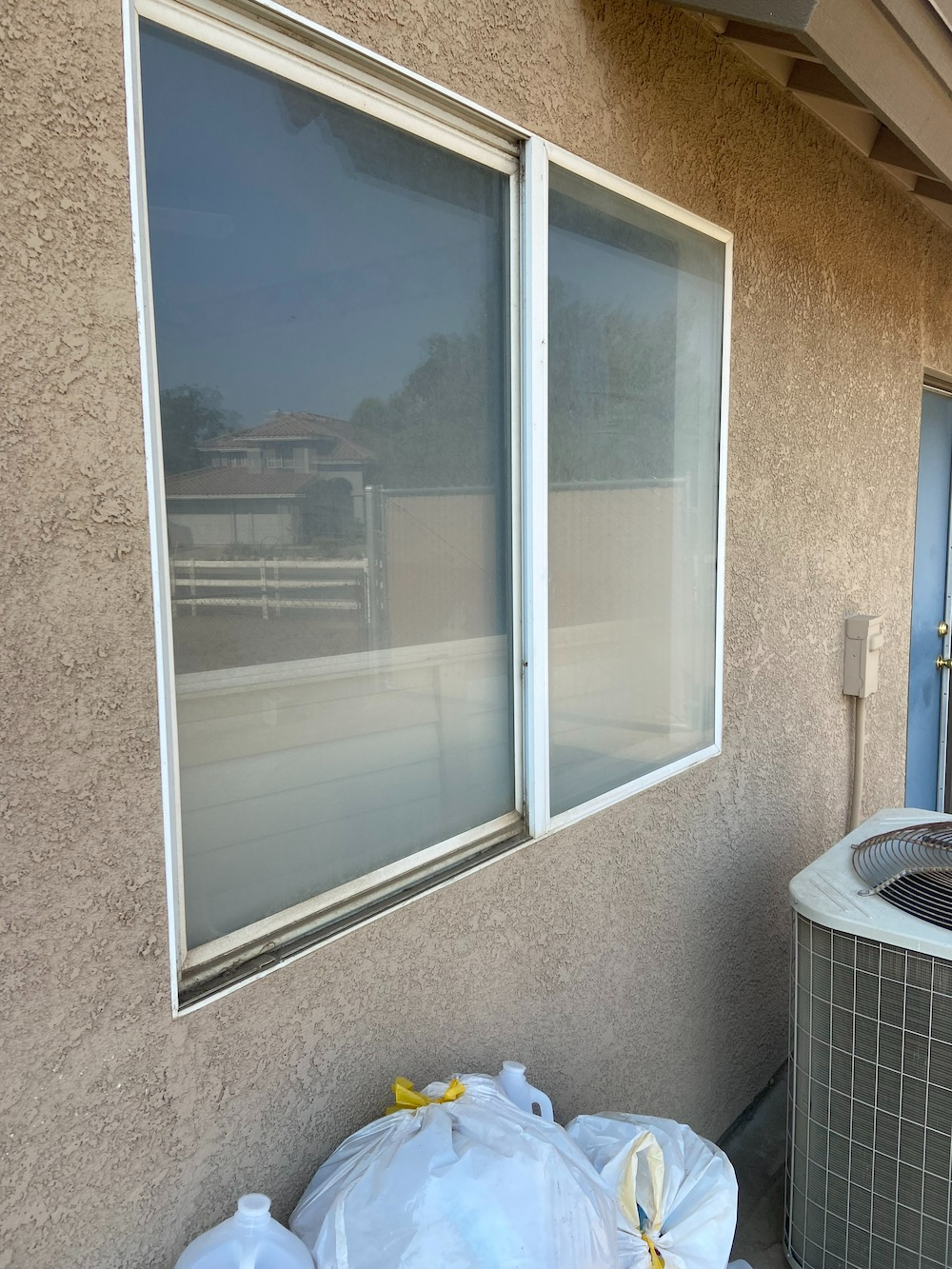 A Building With A Lot Of Trash Bags In Front Of It And A Window