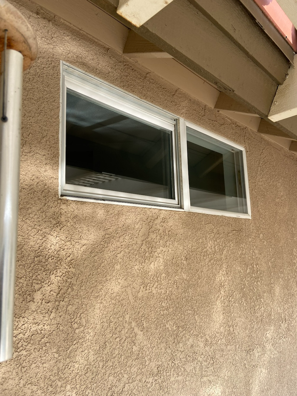 There Are Two Windows On The Side Of A Building