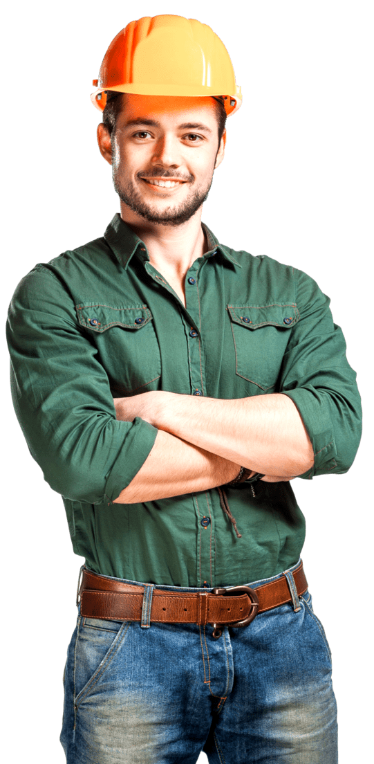 A man wearing a hard hat and a green shirt is standing with his arms crossed.