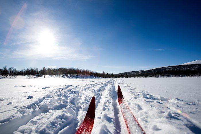 A pair of skis are sitting on top of a snow covered field. 