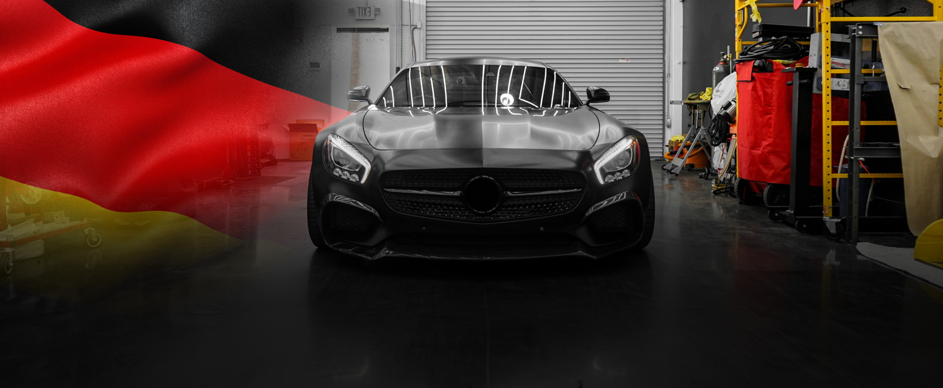 Black car parked inside garage with German flag overlay for background, Expert Auto Repair Service in Indianapolis, IN | Autohaus Merkle