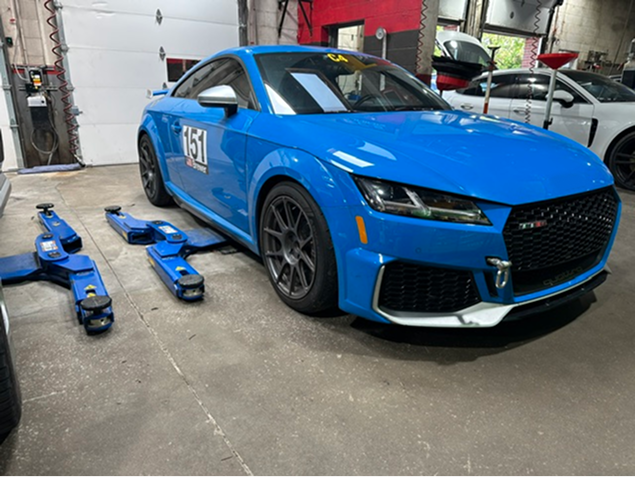 Light blue racing sports car inside of our auto repair garage | Autohaus Merkle