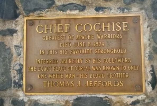 Bronze plaque for Chief Cochise on a stone wall, with engraved historical text.