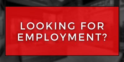 Red sign with white text reading “Looking for employment?”