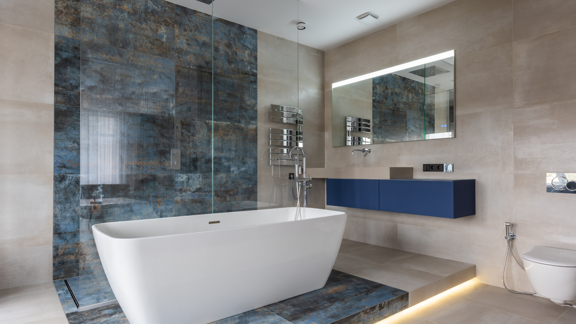 A bathroom with a bathtub , sink , mirror and walk in shower.