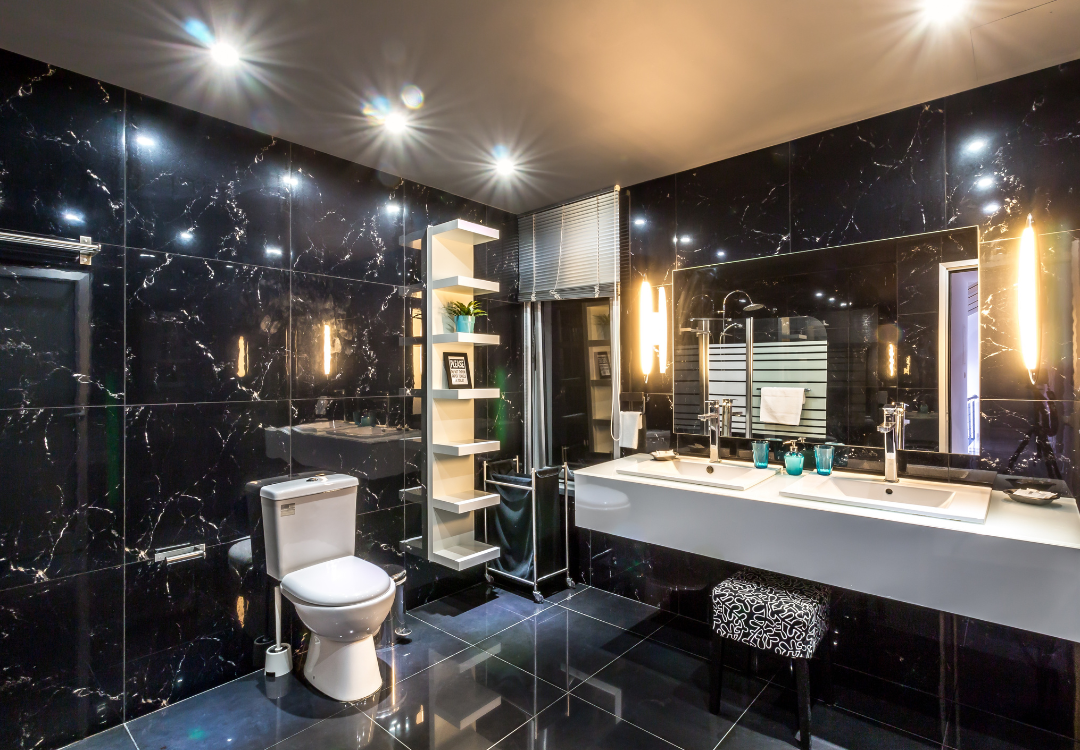 A bathroom with a toilet , sink and mirror.
