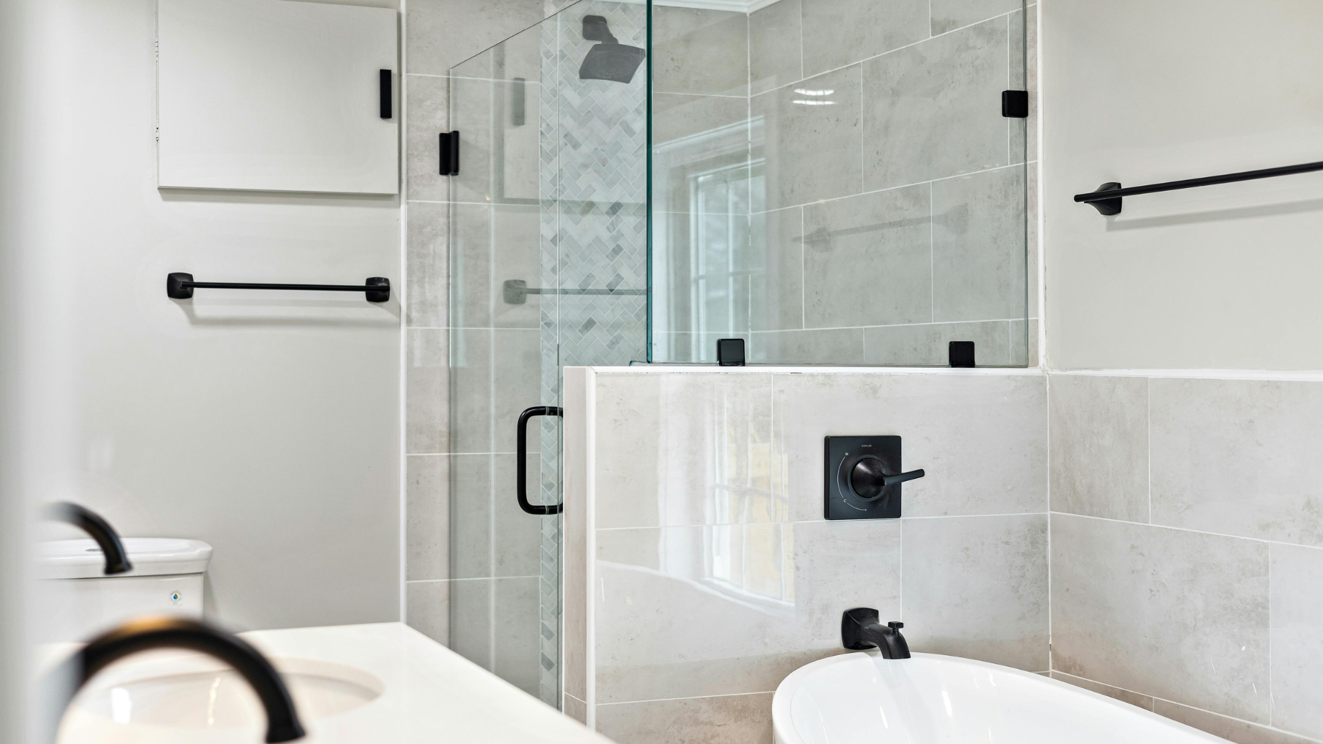 A bathroom with a tub , sink , toilet and shower.